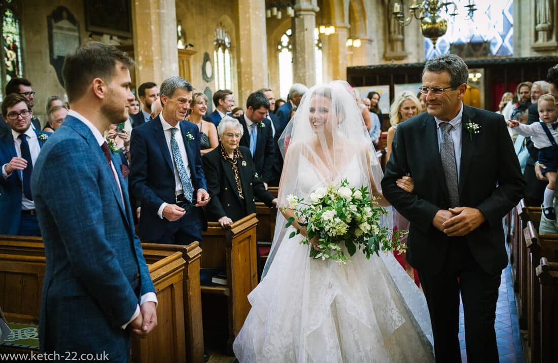 Groom takes a first look at his bride at Winchcombe church ceremony