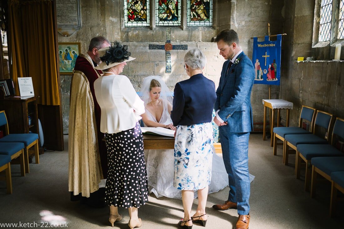 Bride signing registrar at Church wedding