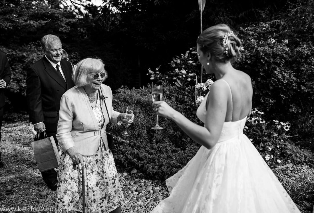 wedding documentary photo of grand ma greeting bride