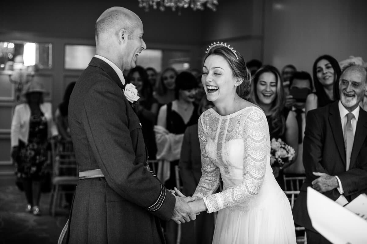 Bride and groom laughing at Country house wedding ceremony