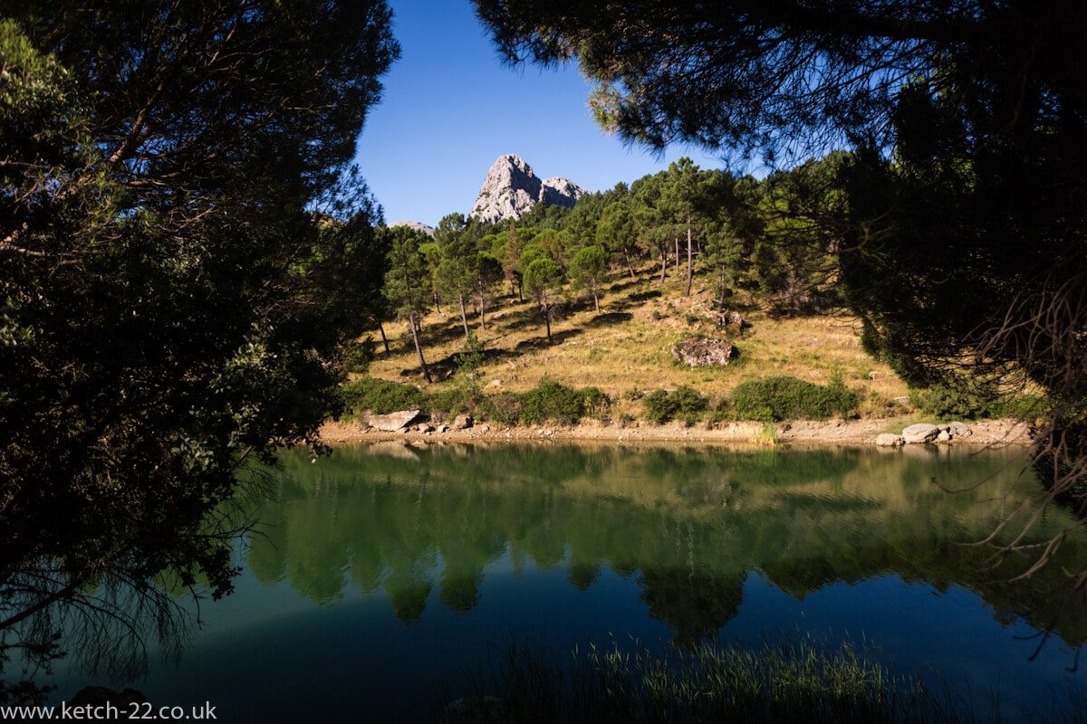 Green lake, green trees, mountain and blue sky's near Grazalema