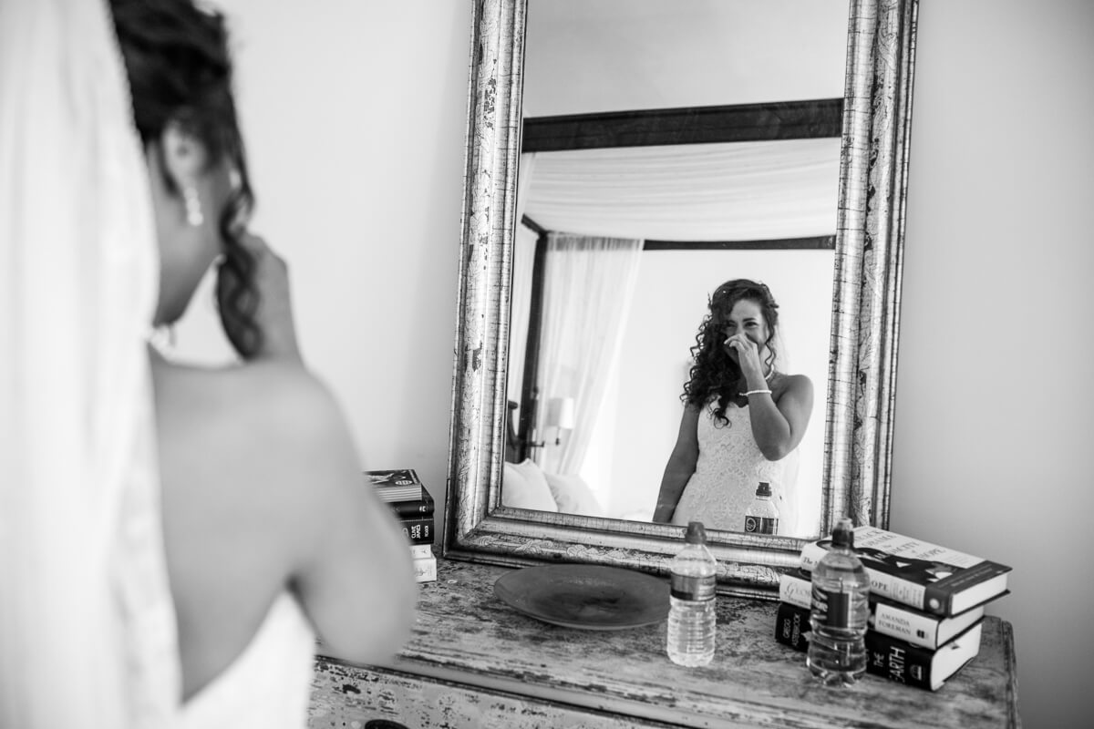 Emotional bride looking in mirror 