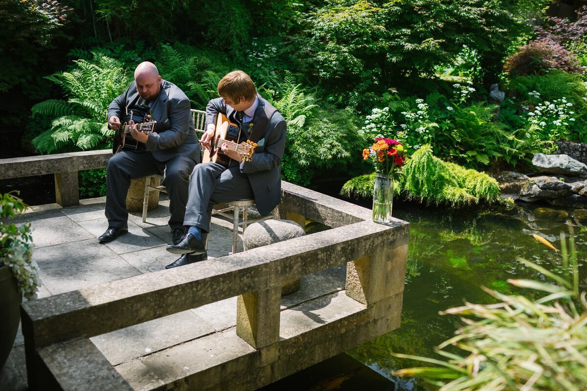 Groomsmen playing guitar at Matara centre wedding