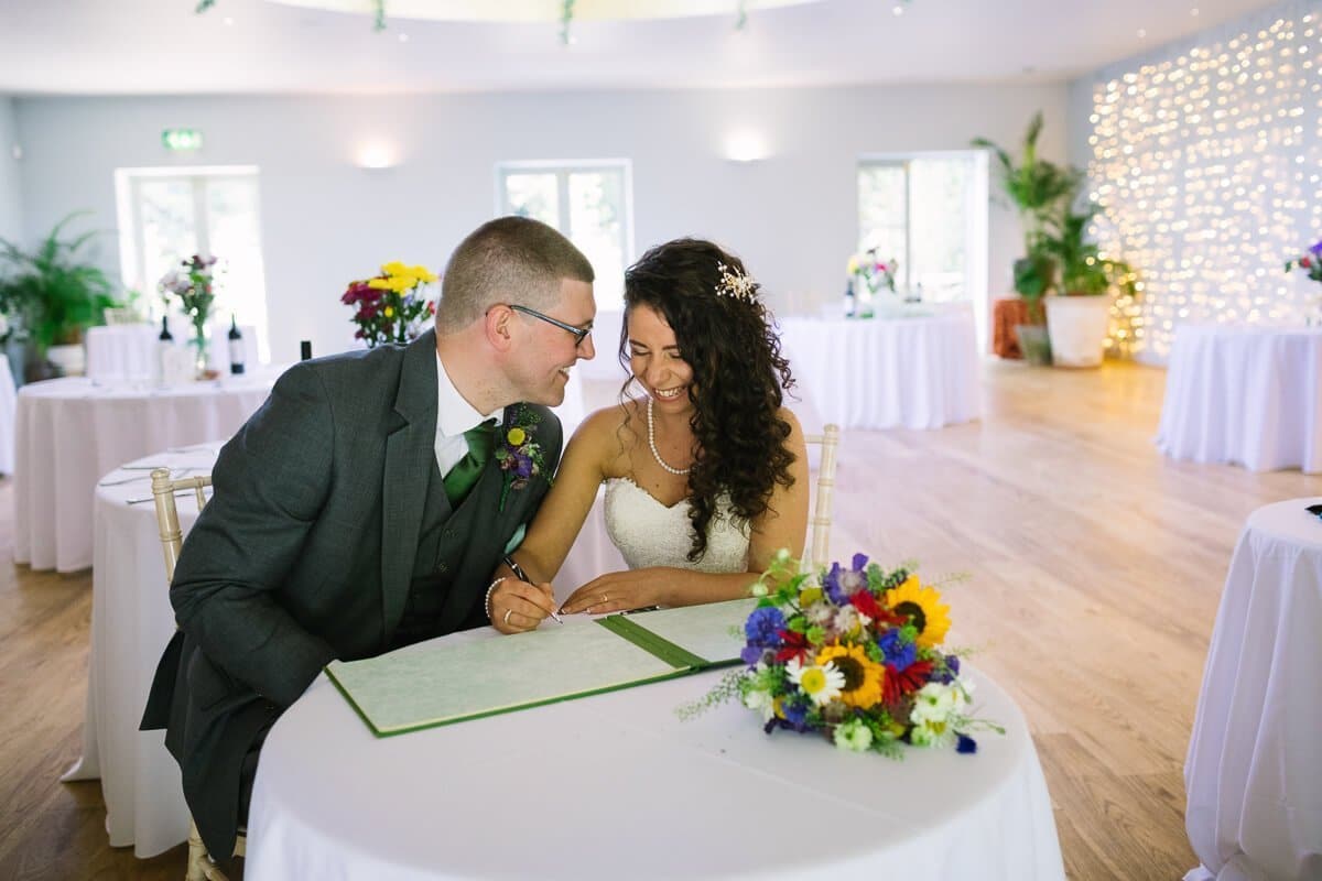 Bride and groom sign the registrar