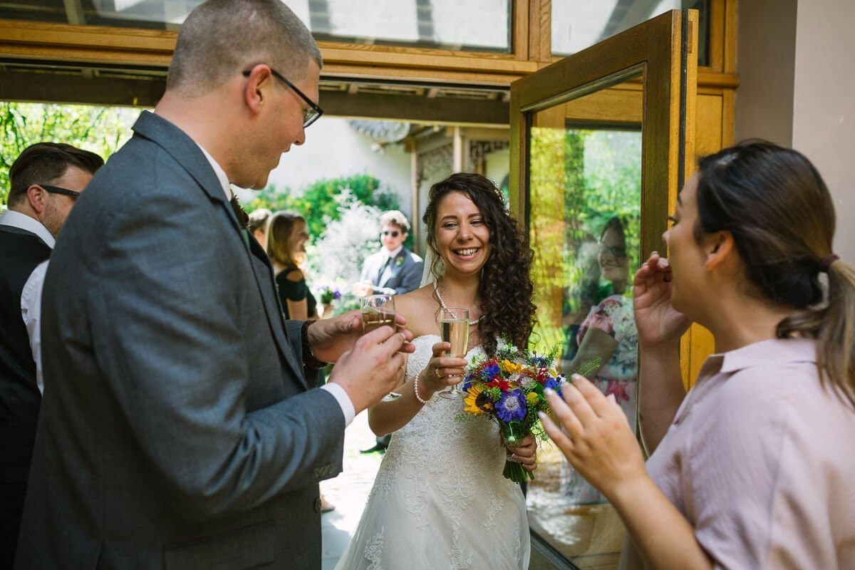 Bride and groom toast each other