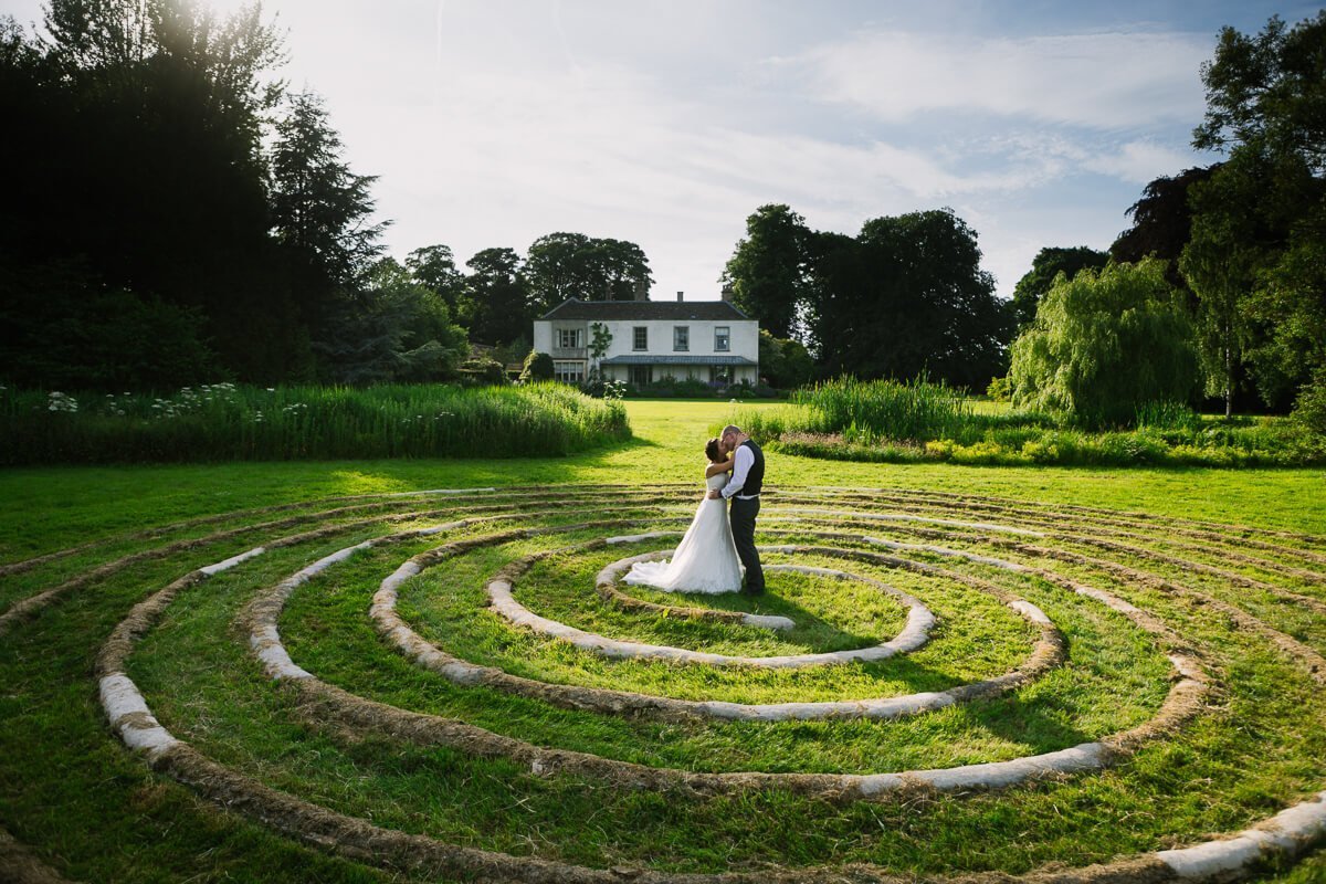 Bride and groom kissing in spiral circle