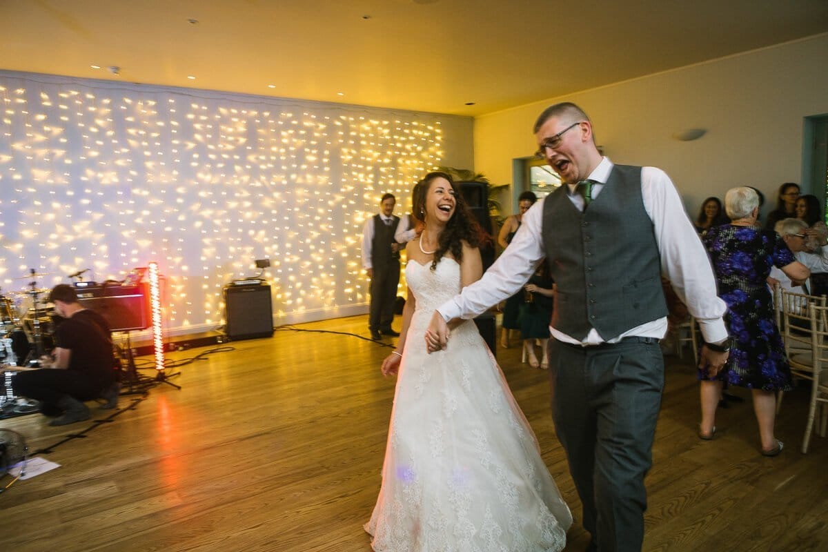 Bride and groom walk on to dance floor