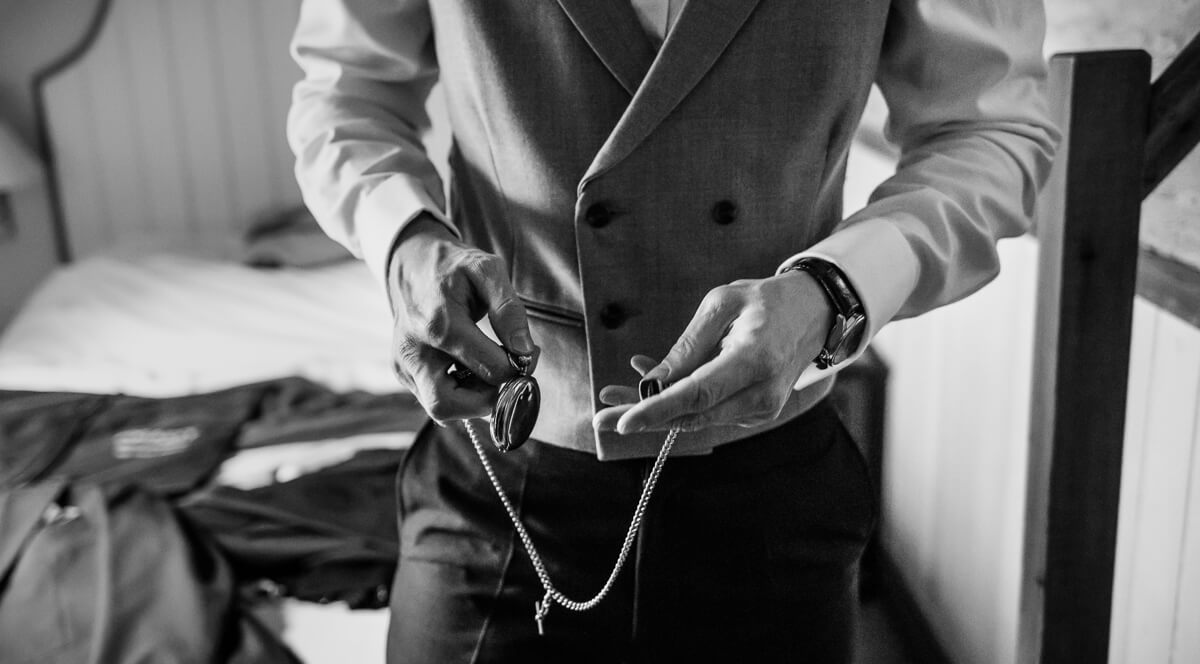 Groom with his grand dad's old watch in his hands