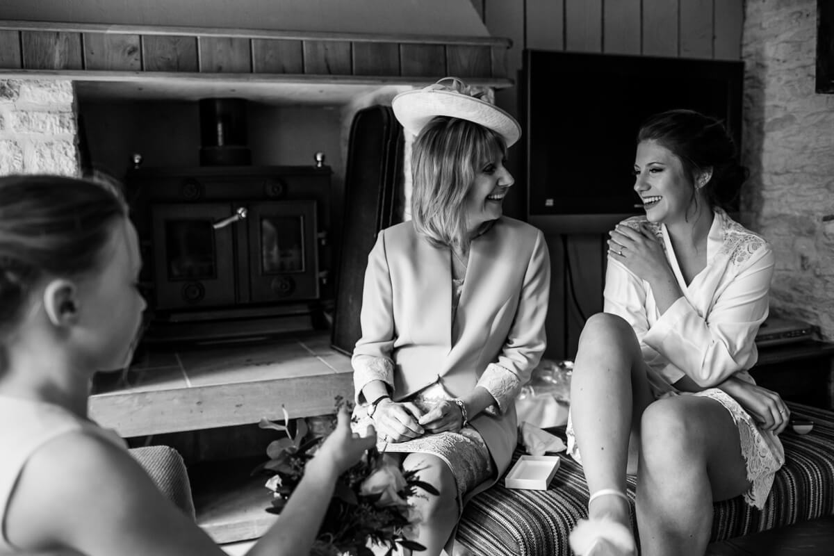 Bride enjoying a private laugh with her mother at Cripps Barn in Gloucestershire
