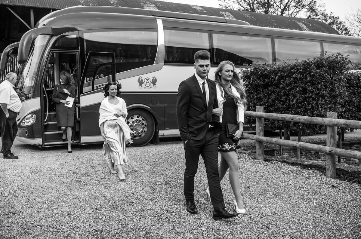 Wedding guests getting off coach