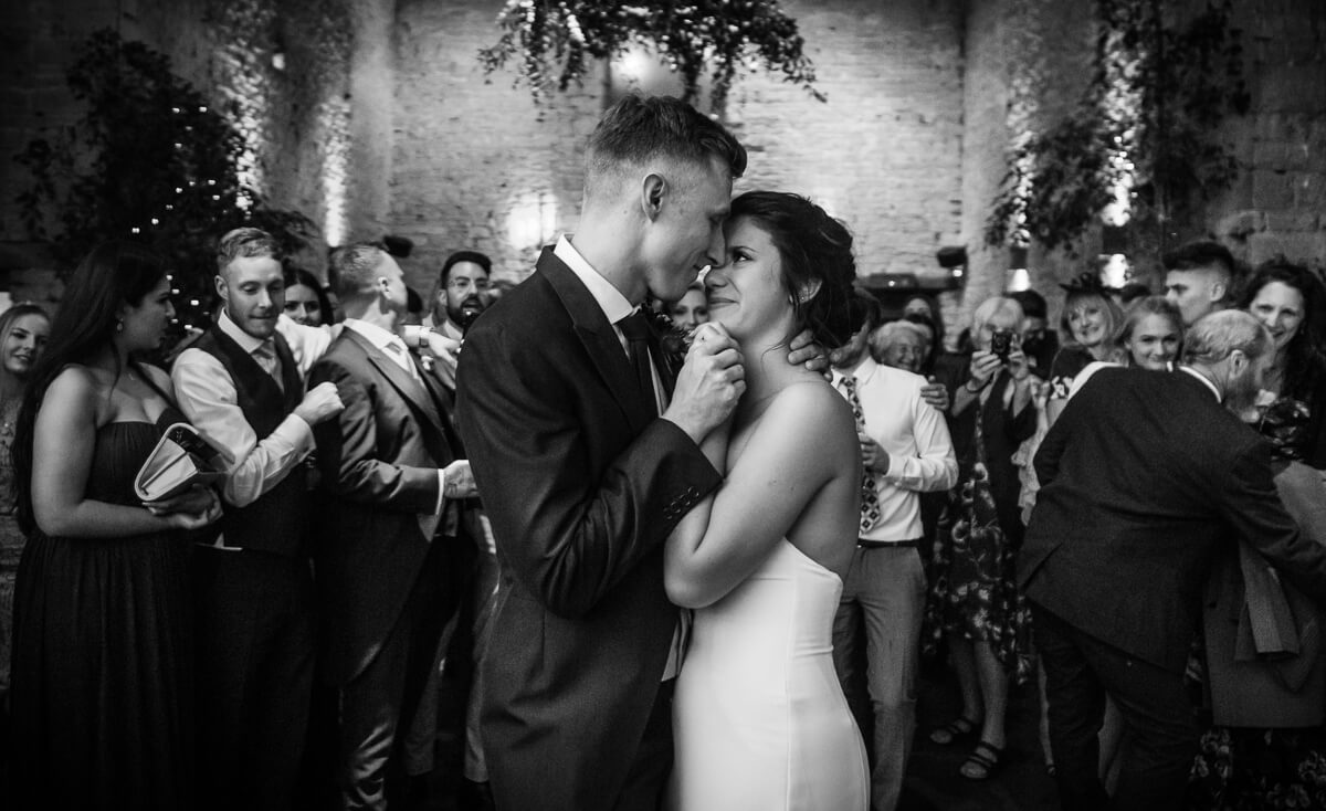 Black and white photo of bride and groom enjoying first dance