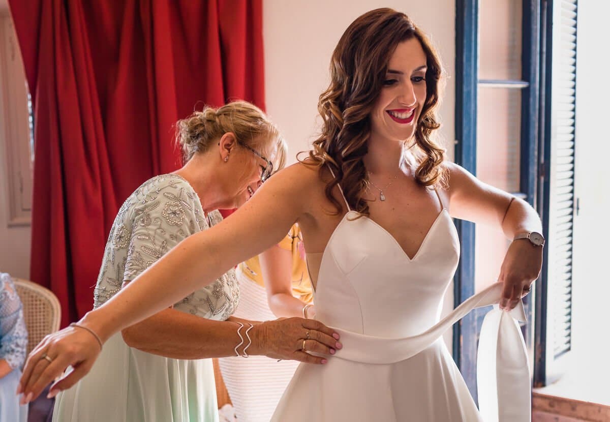 Mother applies final touches to Wedding dress