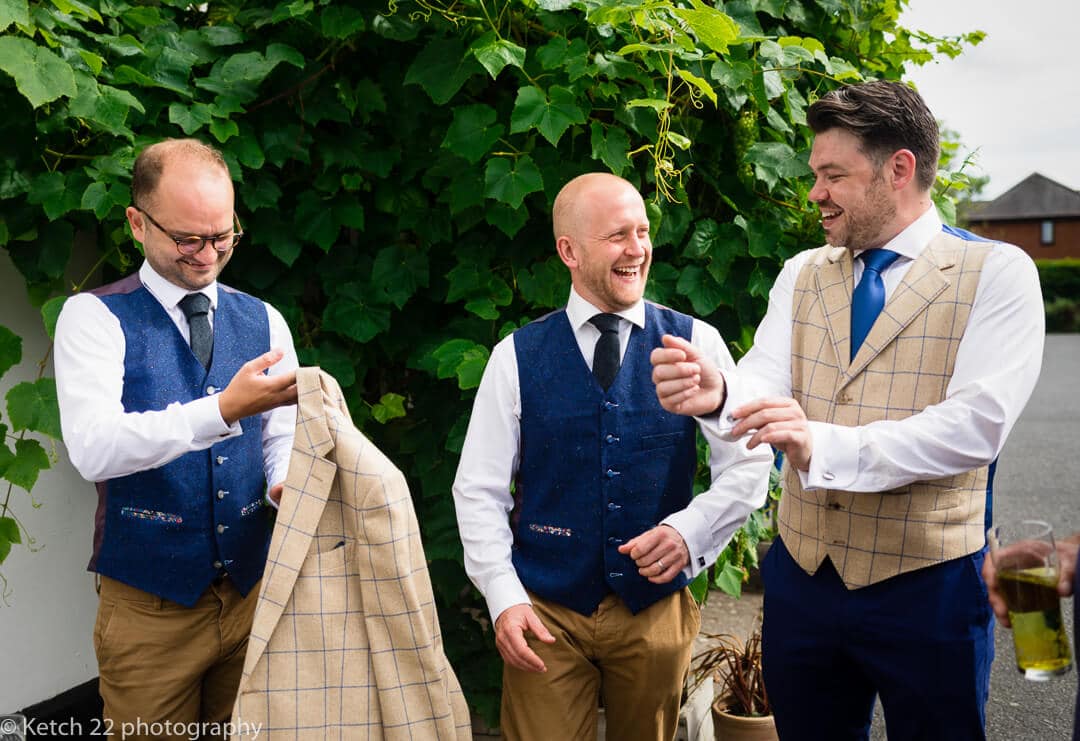 Groom and ushers relaxing and chatting before wedding ceremony