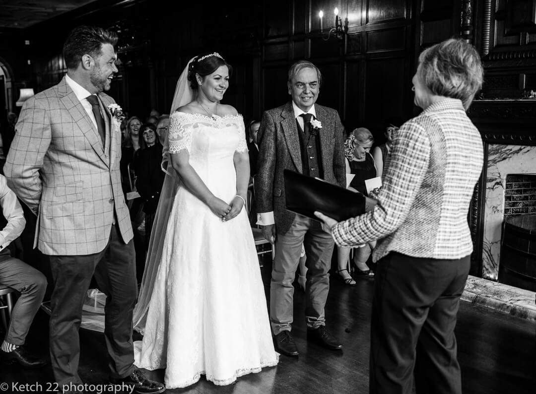 Groom smiling at bride during wedding ceremony at Whitney Court in Herefordshire