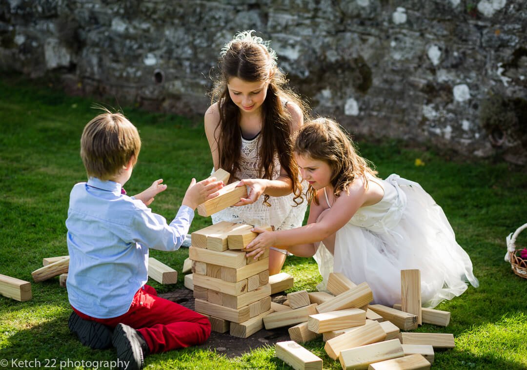 Kids playing games on the lawn at documentary wedding