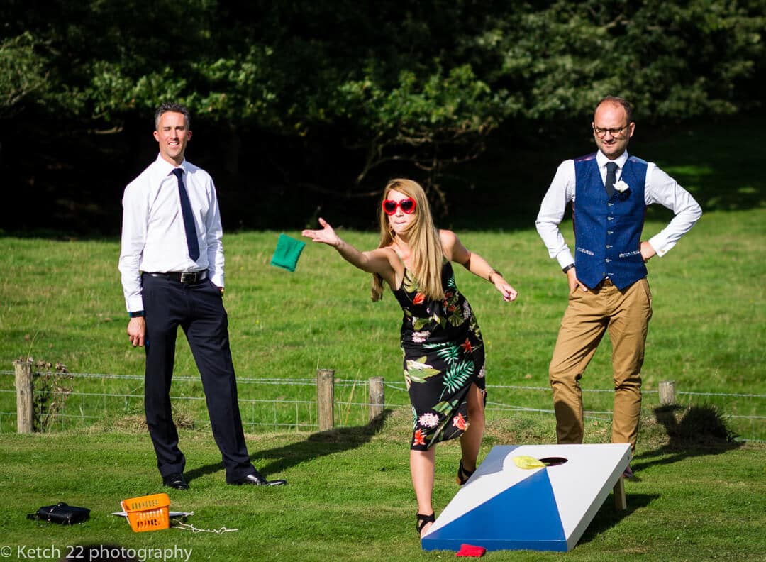 Wedding guests playing games on lawn in Herefordshire