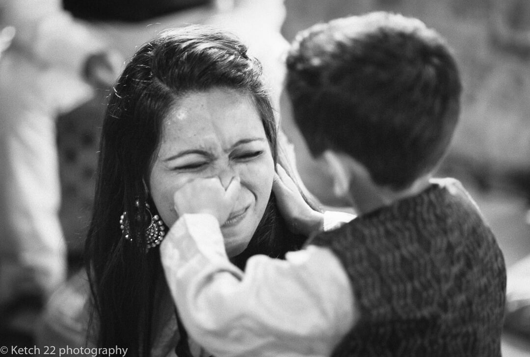 Kid pinching mums nose at Indian Henna night