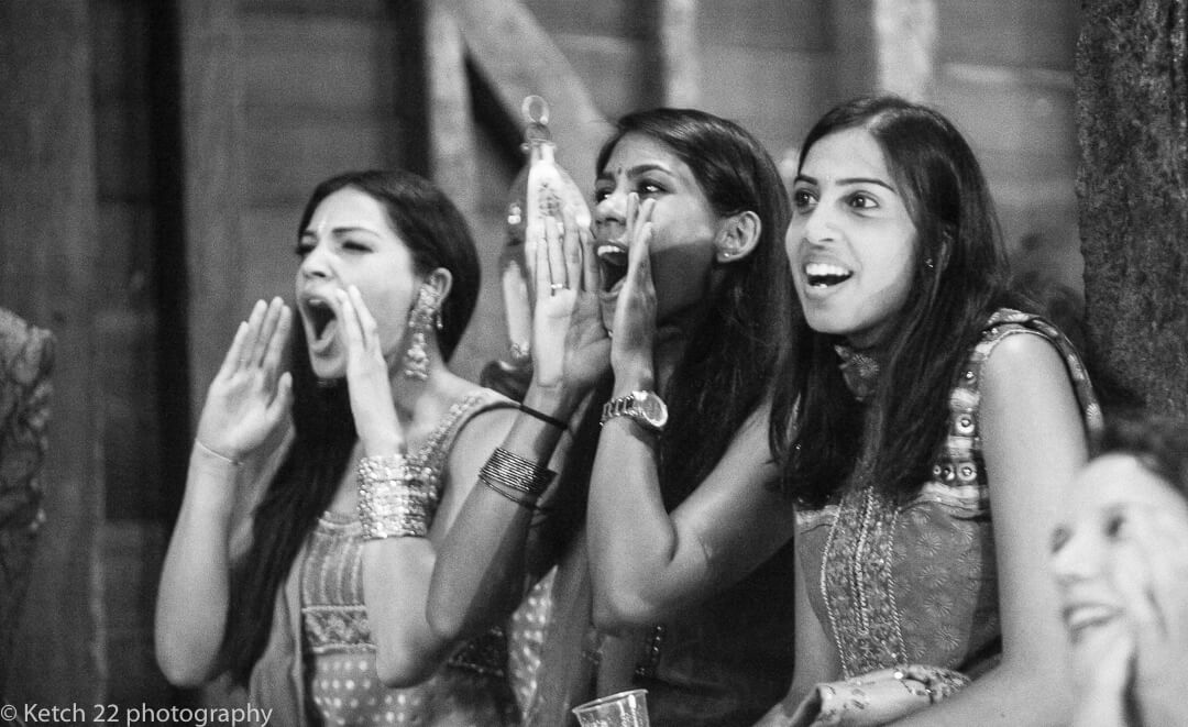 Indian wedding guests cheering and shouting