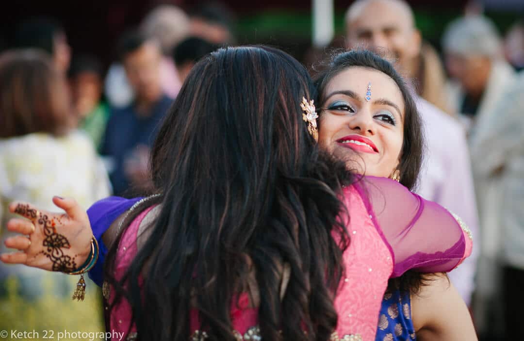 Wedding guests embracing at Hindu celebration