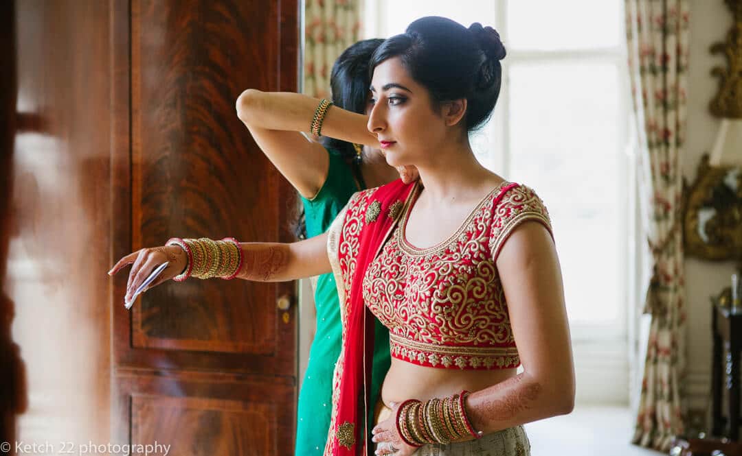 Hindu bride puts on colourful wedding dress at Highclere castle