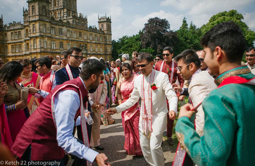 Wedding guests dancing at Hindu wedding 