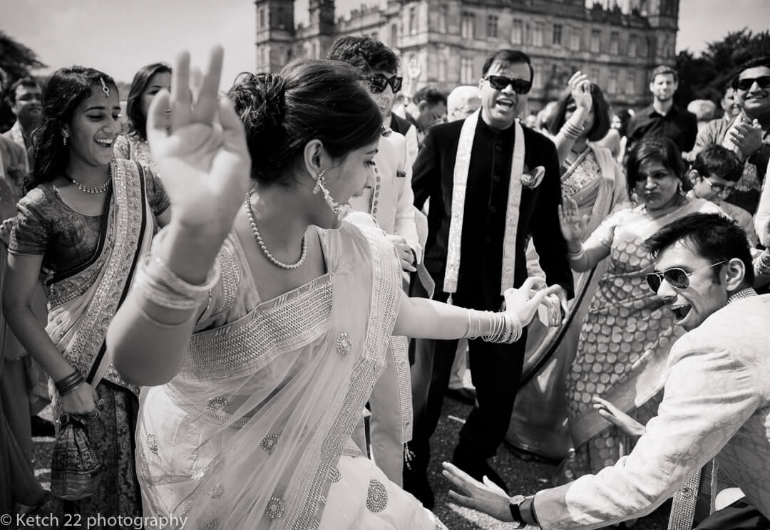 Black and white photo of Indian wedding guests dancing