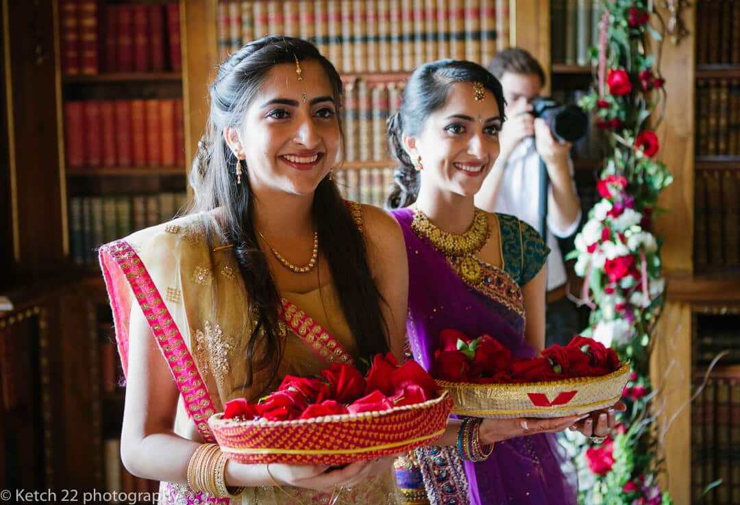 Bridesmaids with flowers at Indian wedding ceremony