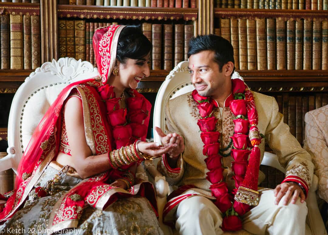 Bride and groom share flower petals at Indian wedding ceremony