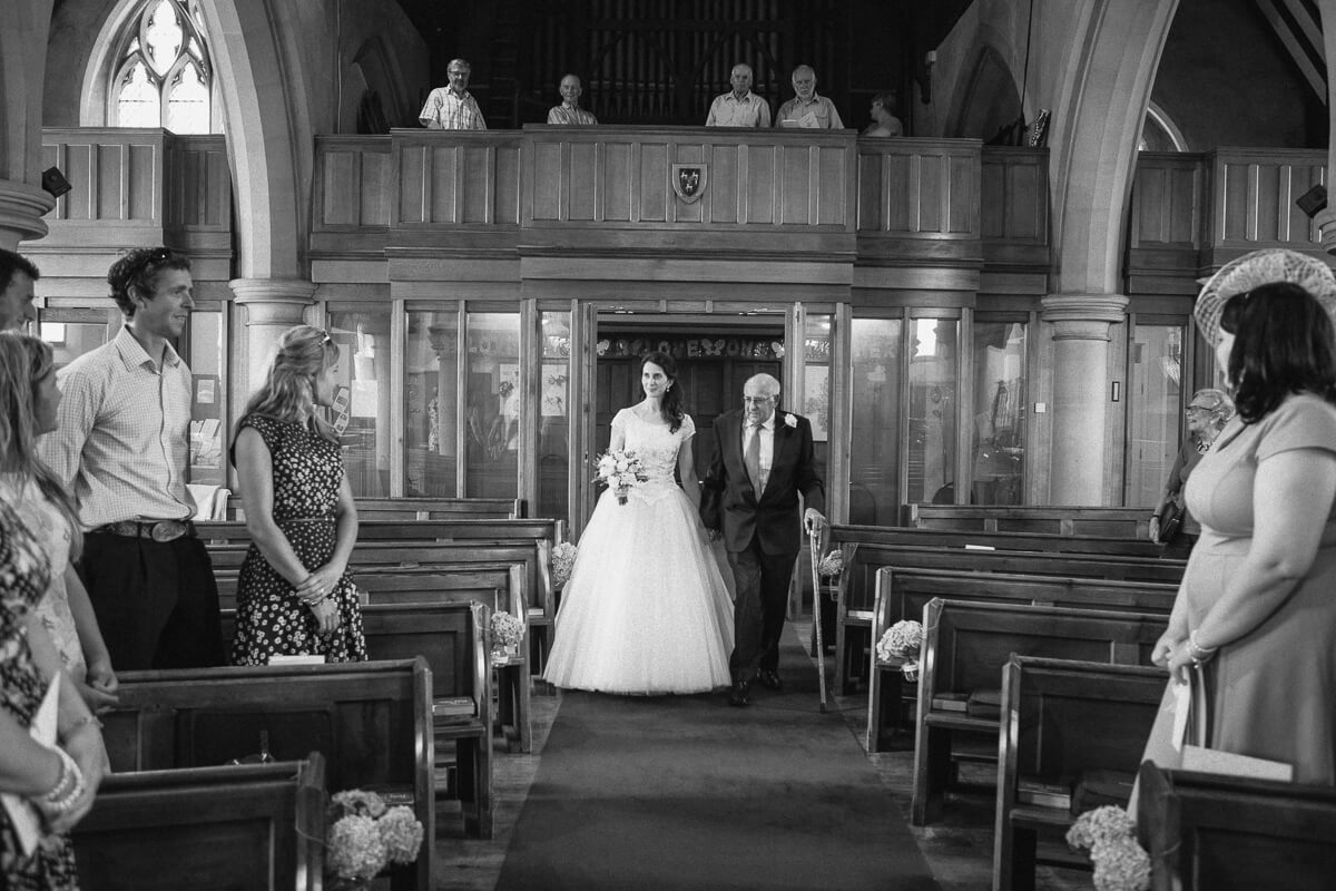 Bride and father entering church wedding