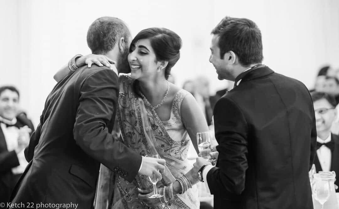 Bride hugging best man after wedding speech