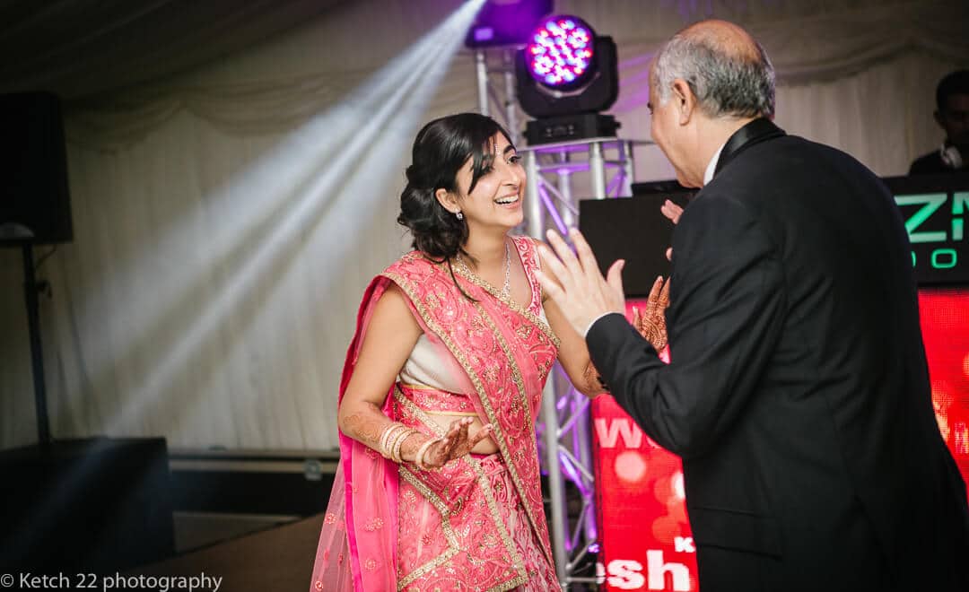 Bride dancing with her father at Indian wedding at Micklefield Hall