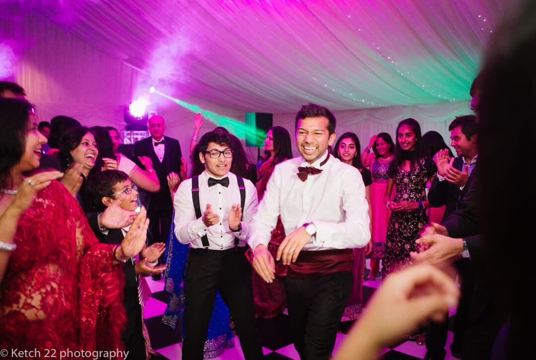 Groom dancing at Indian wedding reception at Micklefield Hall in London