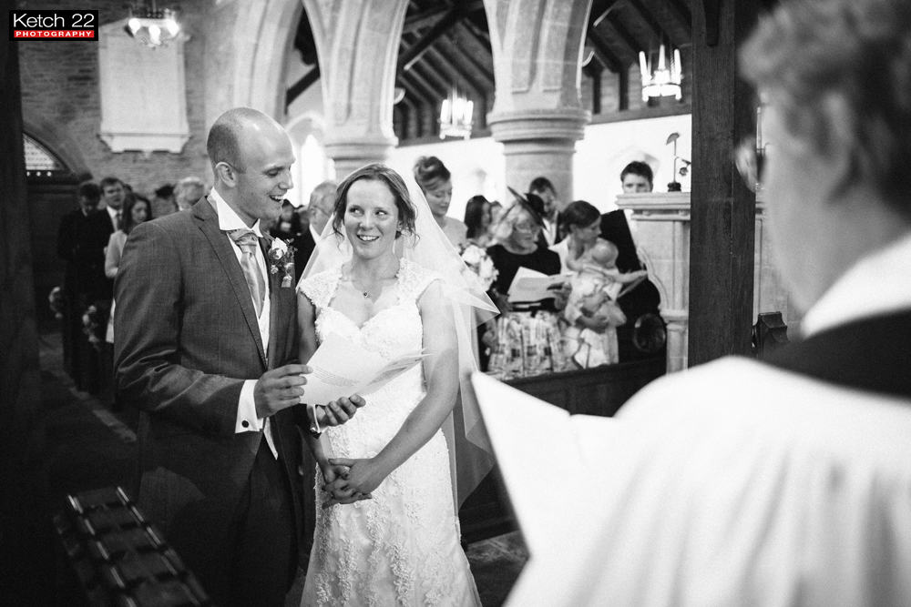 Bride and groom singing during wedding ceremony in Herefordshire
