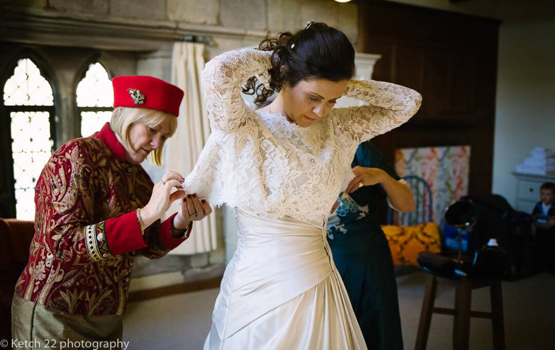 Bride putting on wedding dress at Brinsop Court