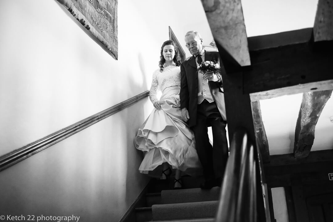 Father and bride descending stairs at Country house wedding