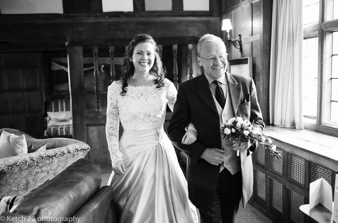 Father and bride walking to wedding ceremony room in Herefordshire