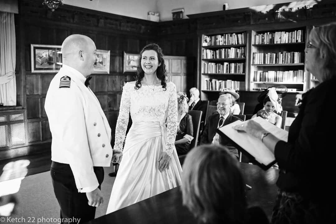 Bride and groom exchanging vows in Library at Brinsop Court