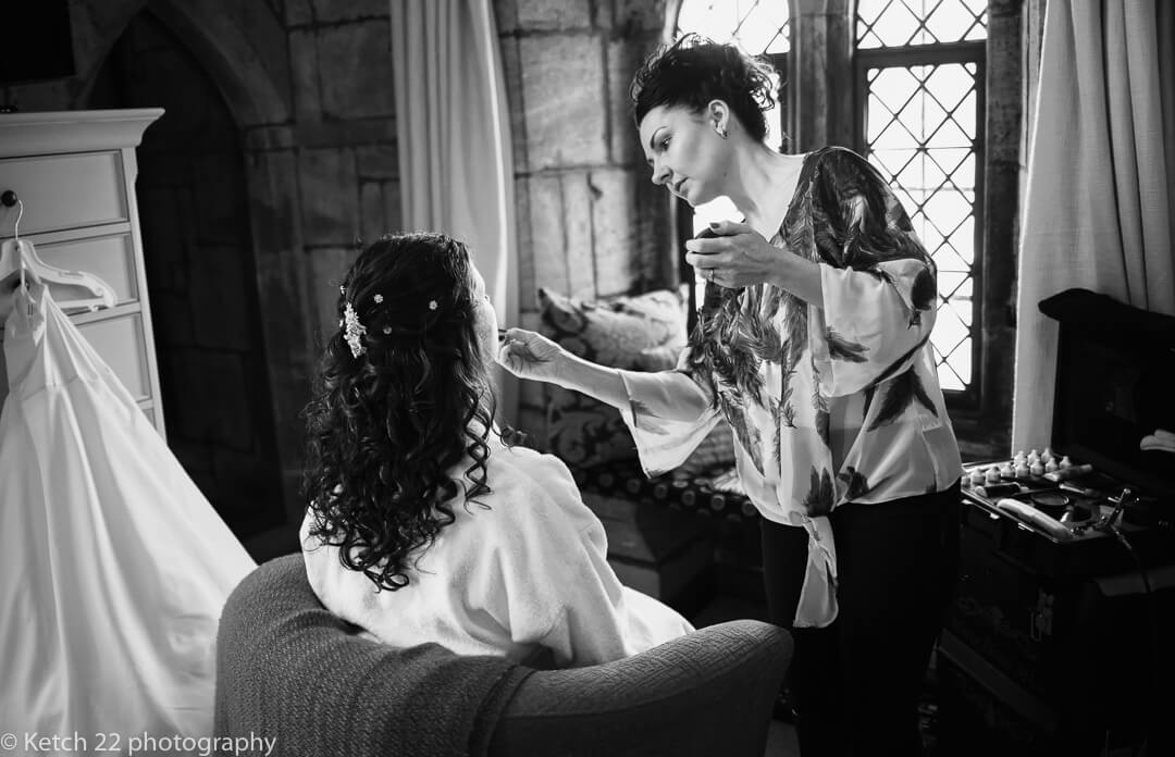 Bride having make up applied at Brinsop Court wedding