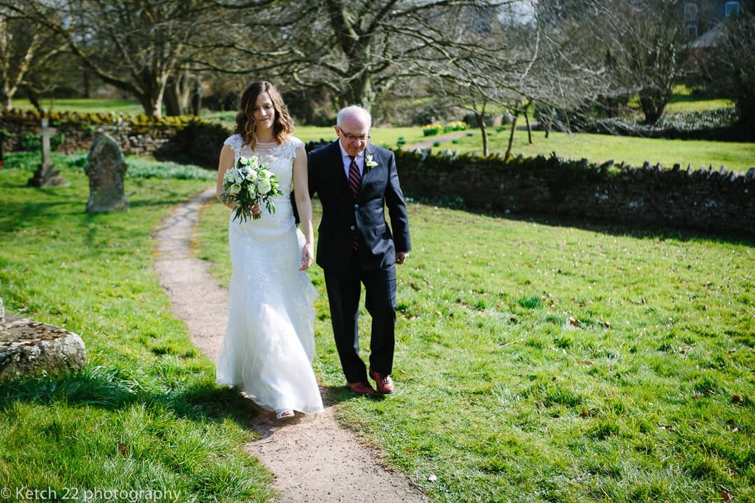 Father and bride arriving at church at spring wedding