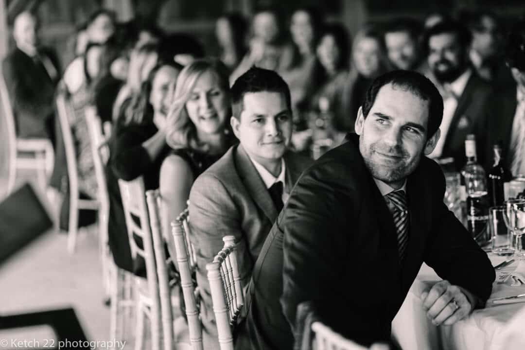 Wedding guests listening to wedding speechs at country House wedding