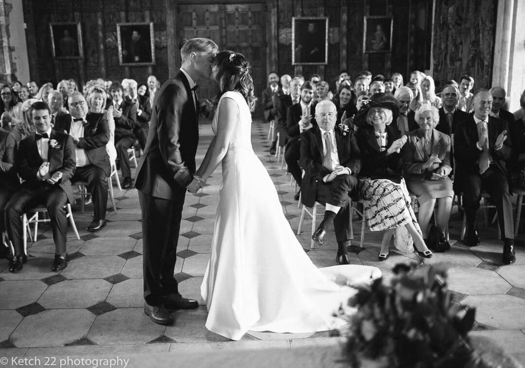 Bride and groom kissing at wedding ceremony at berkeley castle in Gloucestershire