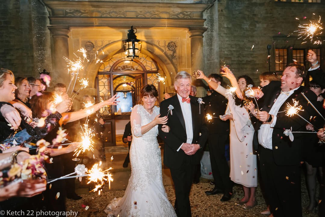 Bride and groom walking through a blaze of sparklers at Foxhill Manor Wedding