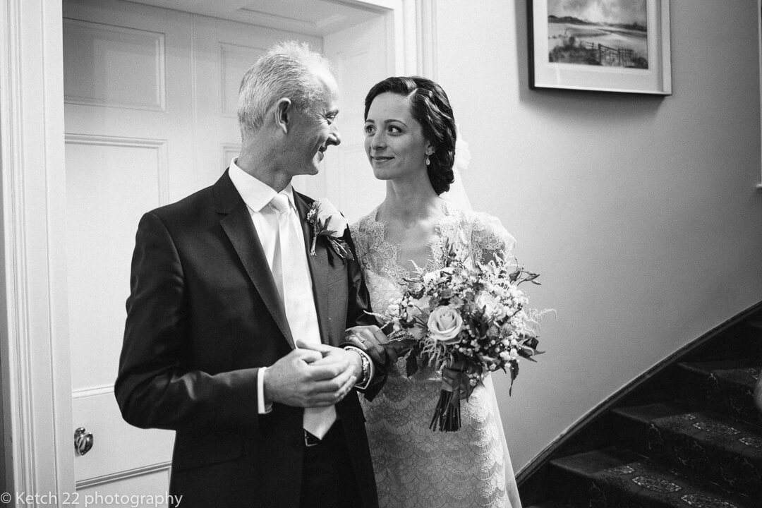 Proud father looking at bride and daughter before wedding ceremony