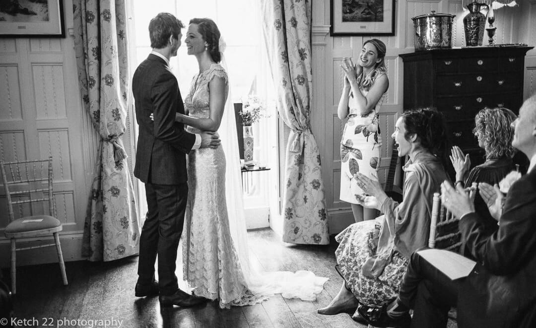 Reportage photo of bride and groom embracing at wedding ceremony