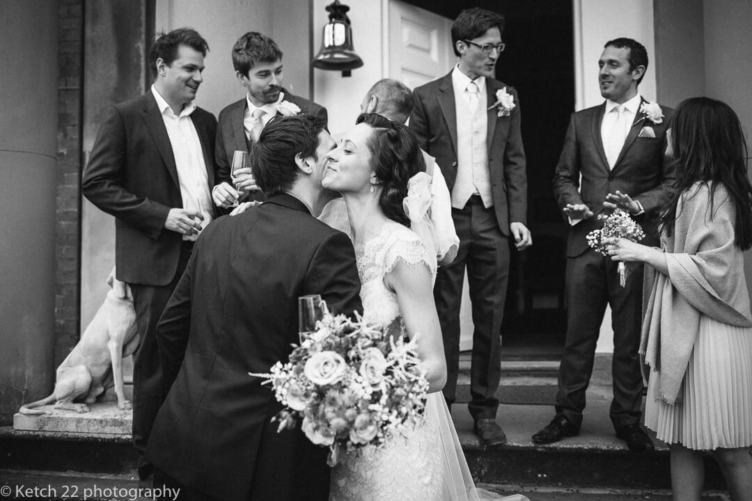 Bride kissing wedding guest at Country House wedding in Herefordshire