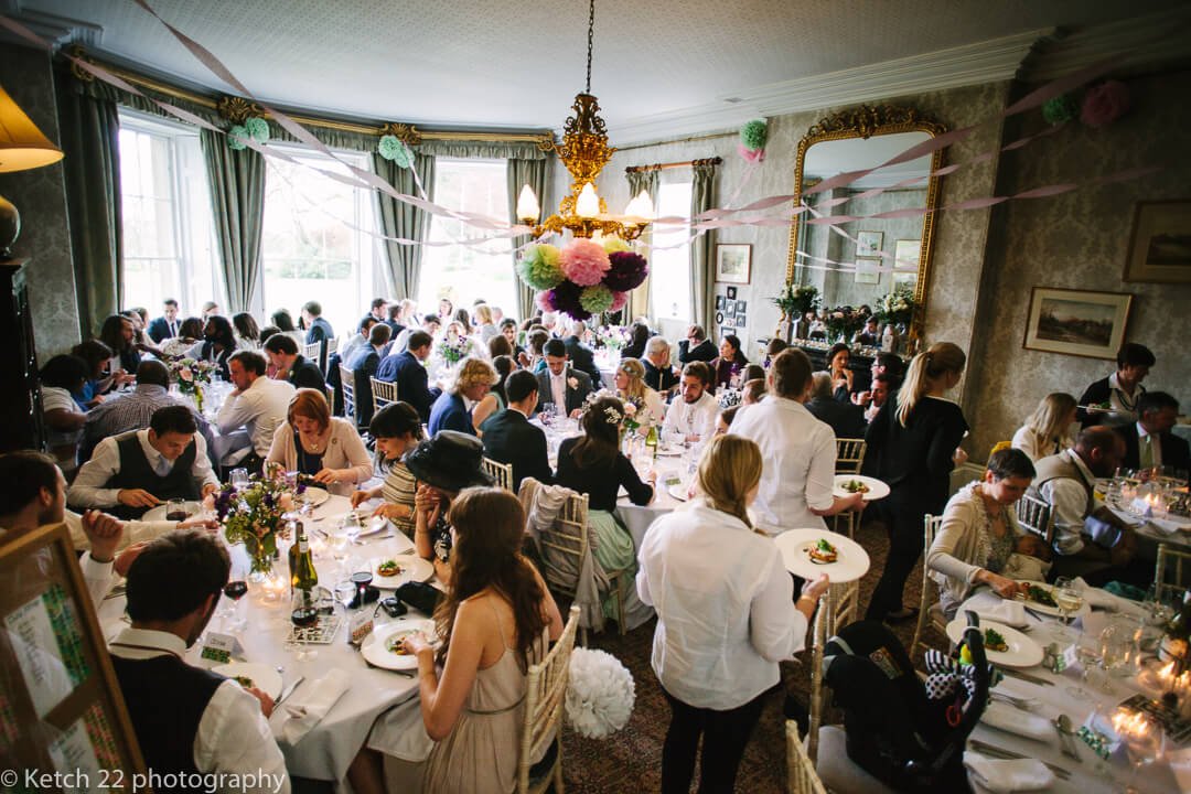 Over view of wedding guests eating in dinning room at Homme House