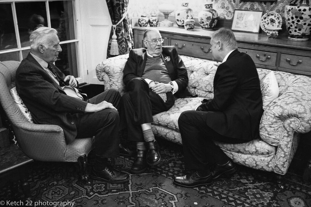 relaxed old men chatting at wedding reception