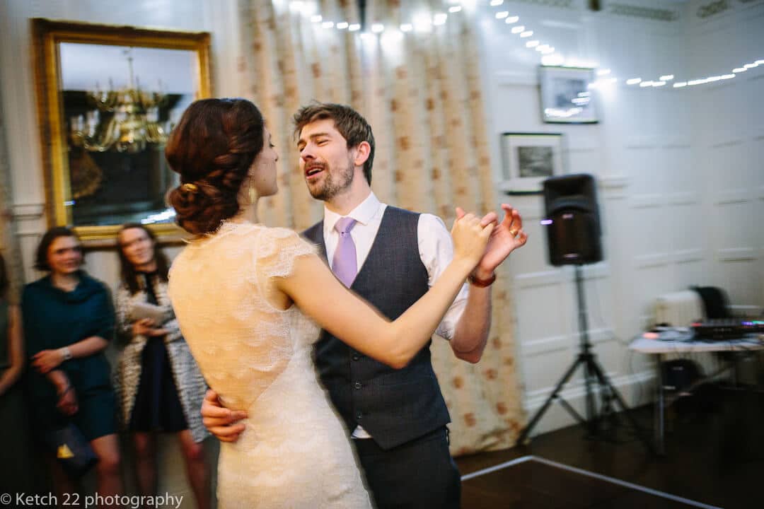 Candid wedding photo of bride and groom at first dance