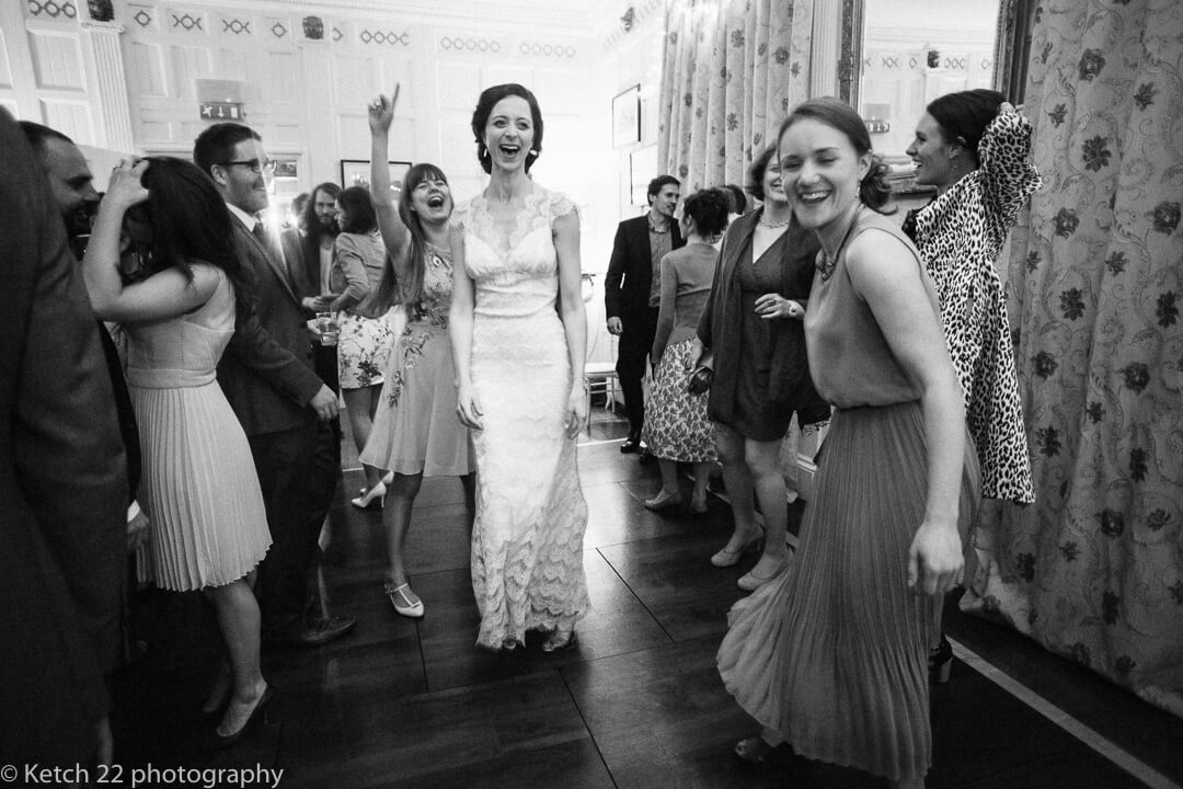 Bride and wedding guests dancing at reception