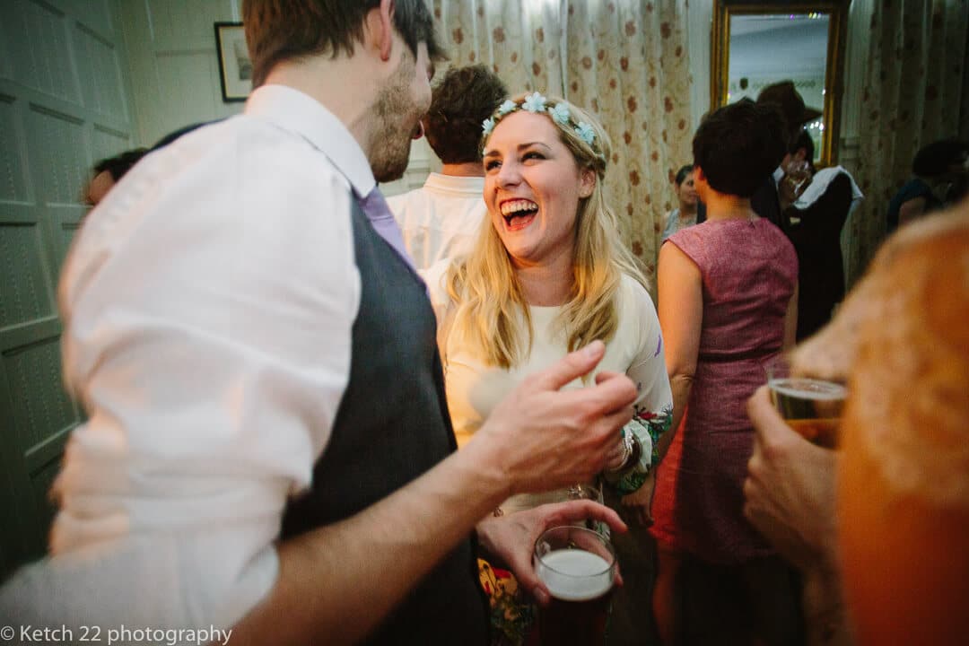 Wedding guest chatting to groom at reception